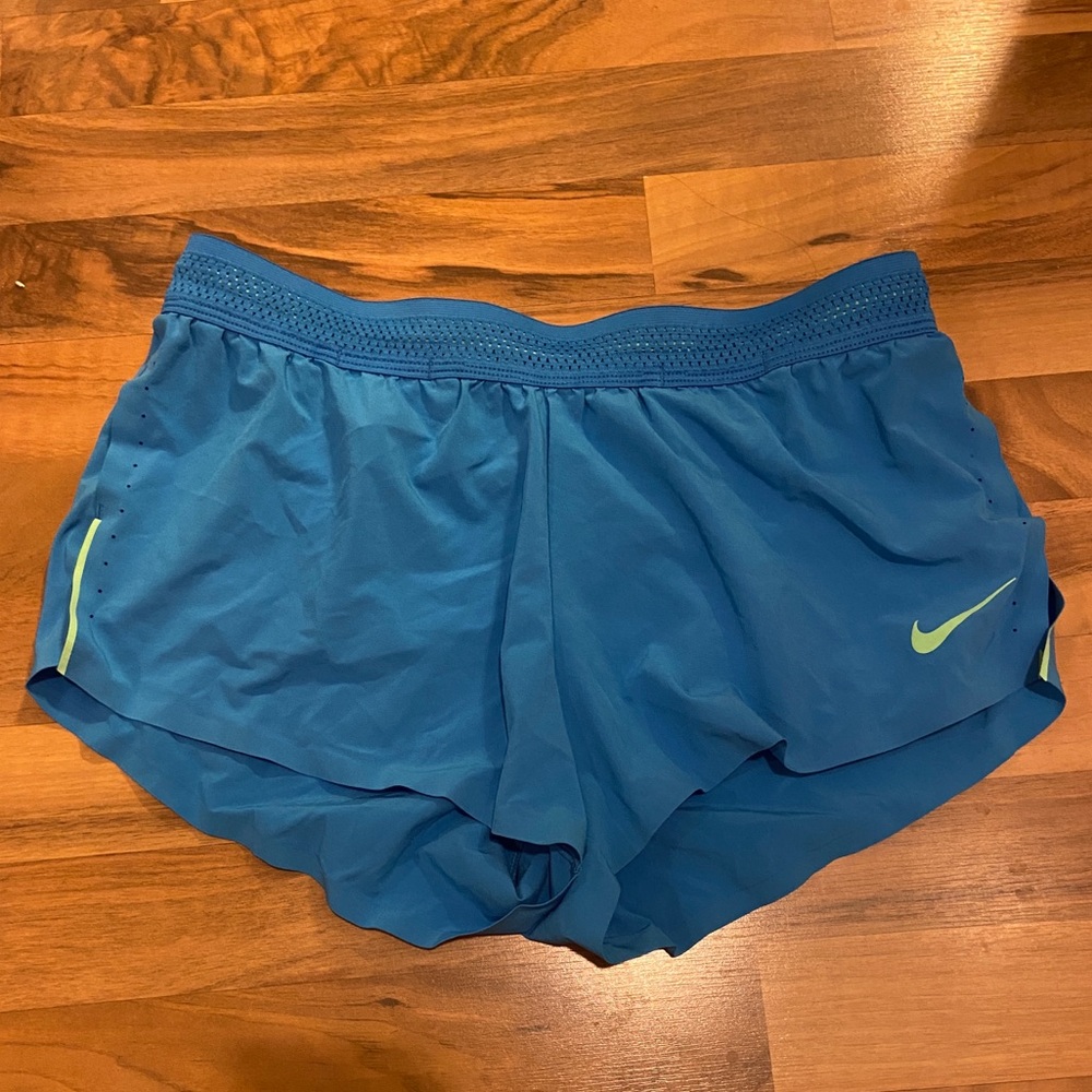 Nike. Stretchy workout blue shorts. Side slits. Back zipper.